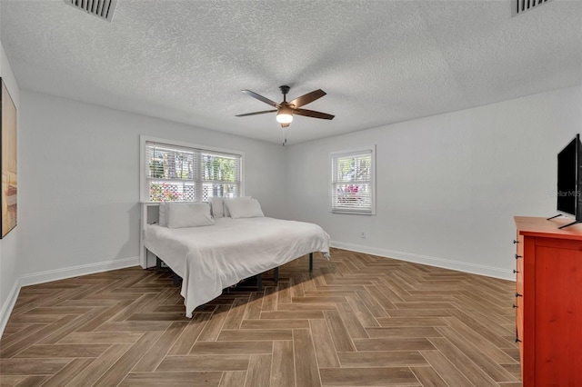 1003 Shore Dr, Kissimmee, FL 34744 - bedroom featuring baseboards, ceiling fan, a textured ceiling, and visible vents