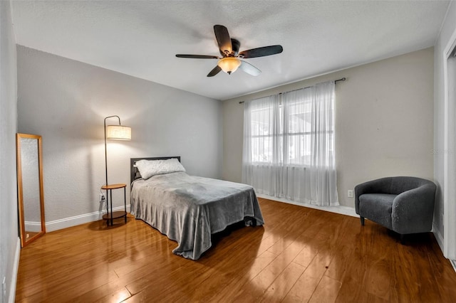 1003 Shore Dr, Kissimmee, FL 34744 - bedroom with baseboards, a ceiling fan, and wood finished floors