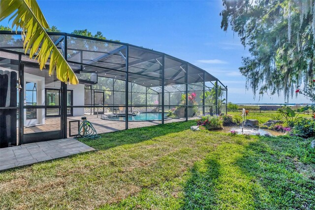 1003 Shore Dr, Kissimmee, FL 34744 - view of yard featuring a patio, a lanai, and an outdoor pool