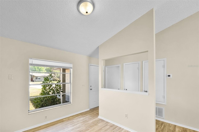 288 Howard Blvd, Longwood, FL 32750 - spare room with a textured ceiling, visible vents, wood finished floors, and vaulted ceiling