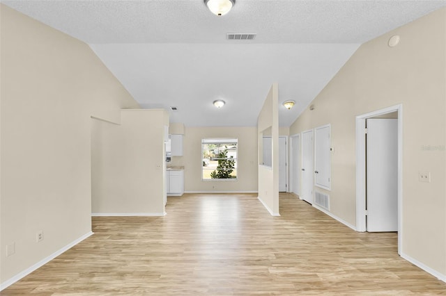 288 Howard Blvd, Longwood, FL 32750 - unfurnished living room featuring visible vents, vaulted ceiling, and light wood-type flooring