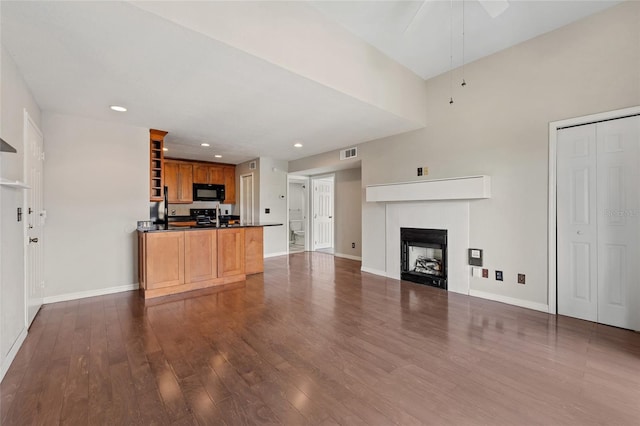 390 Lake Placid Ct Unit 304, Altamonte Springs, FL 32701 - unfurnished living room with dark wood finished floors, visible vents, baseboards, a fireplace, and ceiling fan