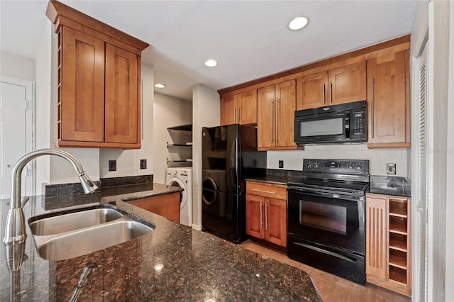 390 Lake Placid Ct Unit 304, Altamonte Springs, FL 32701 - kitchen with brown cabinetry, black appliances, washer / clothes dryer, and a sink