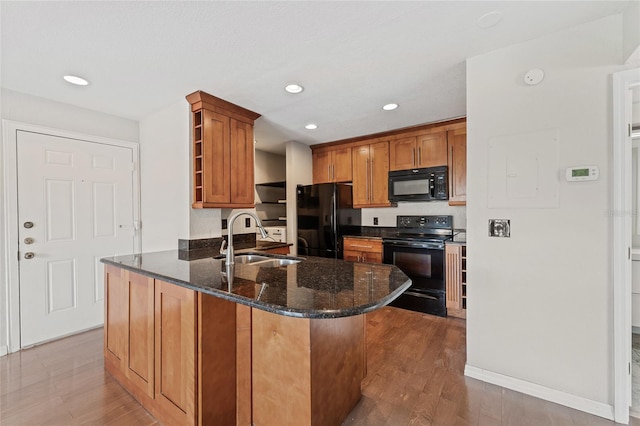 390 Lake Placid Ct Unit 304, Altamonte Springs, FL 32701 - kitchen with brown cabinets, open shelves, a sink, black appliances, and a peninsula