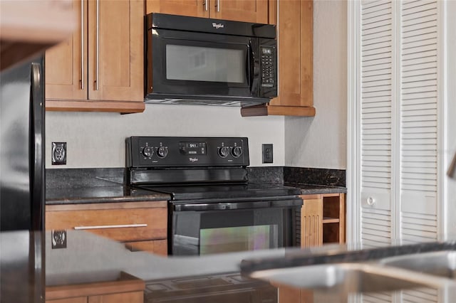 390 Lake Placid Ct Unit 304, Altamonte Springs, FL 32701 - kitchen with brown cabinets and black appliances