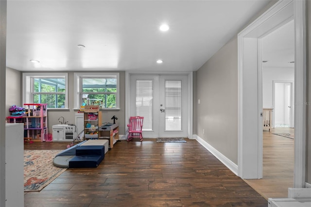 recreation room featuring hardwood / wood-style floors, french doors, and recessed lighting