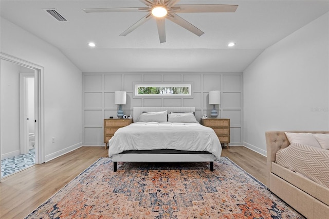 bedroom featuring lofted ceiling, light wood-style floors, and visible vents