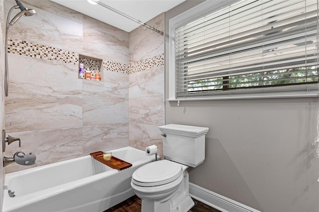 full bath with wood finished floors, toilet, baseboards, and shower / bathtub combination