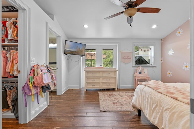 bedroom featuring dark wood finished floors, recessed lighting, baseboards, and a closet