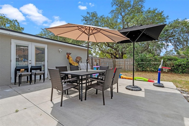 view of patio / terrace featuring fence, outdoor dining space, and french doors