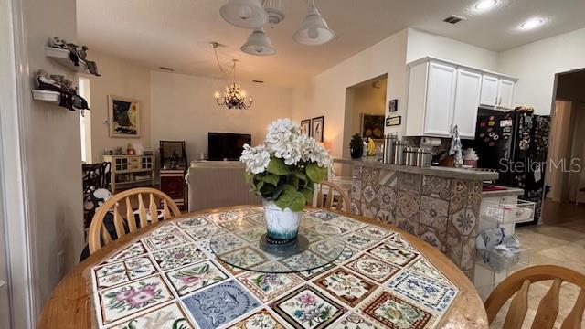 7415 Devereaux St, Reunion, FL 34747 - dining area featuring a chandelier