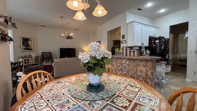 7415 Devereaux St, Reunion, FL 34747 - dining space featuring a chandelier