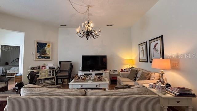 7415 Devereaux St, Reunion, FL 34747 - living area featuring a chandelier and wood finished floors