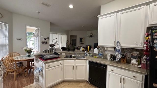 7415 Devereaux St, Reunion, FL 34747 - kitchen featuring dishwasher, a peninsula, white cabinets, and recessed lighting