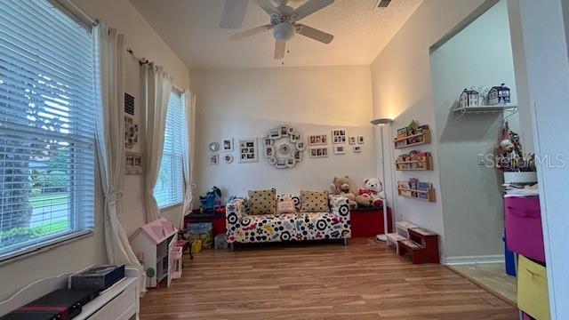 7415 Devereaux St, Reunion, FL 34747 - sitting room with ceiling fan, healthy amount of natural light, and wood finished floors