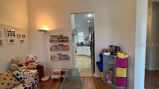 7415 Devereaux St, Reunion, FL 34747 - game room with wood finished floors