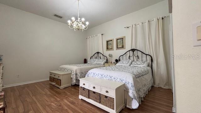 7415 Devereaux St, Reunion, FL 34747 - bedroom with wood finished floors and a chandelier