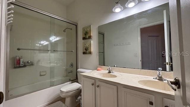 7415 Devereaux St, Reunion, FL 34747 - bathroom with double vanity and combined bath / shower with glass door