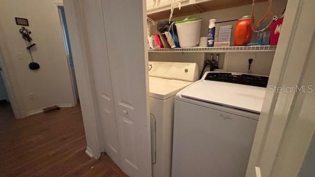 7415 Devereaux St, Reunion, FL 34747 - laundry area with wood finished floors and separate washer and dryer