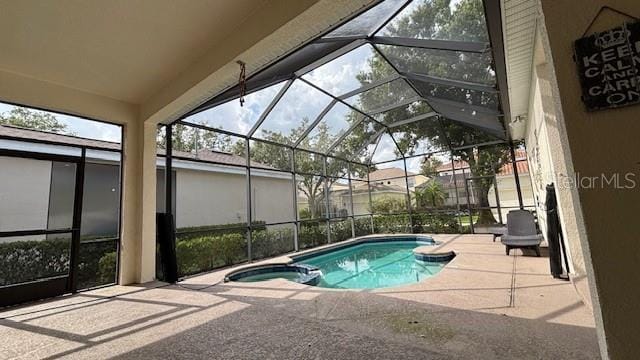 7415 Devereaux St, Reunion, FL 34747 - view of pool with a patio, a pool with connected hot tub, and glass enclosure