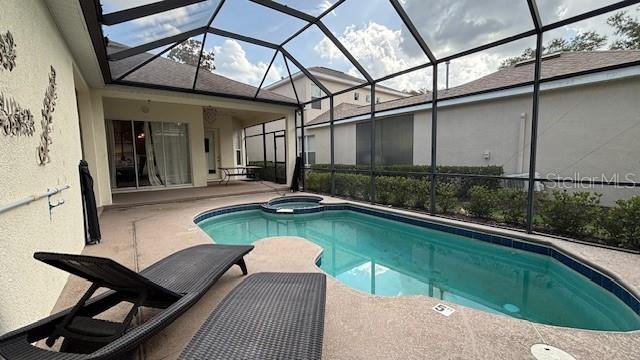 7415 Devereaux St, Reunion, FL 34747 - view of pool with a patio, a lanai, and a pool with connected hot tub