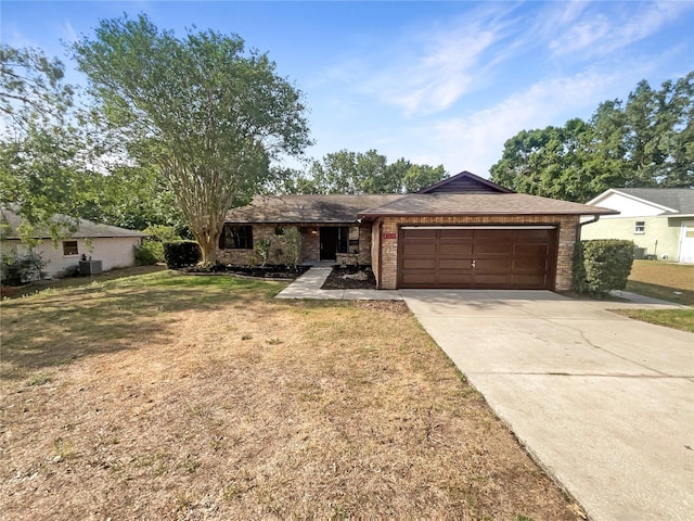 12610 Bay Hill Dr, Grand Island, FL 32735 - single story home featuring driveway, brick siding, a front yard, and a garage