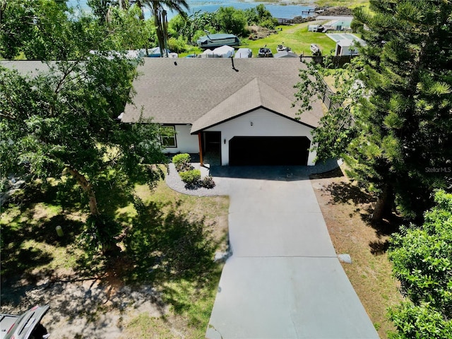 3328 Fox Rdg, Winter Haven, FL 33884 - view of front of property featuring a garage, concrete driveway, and a shingled roof