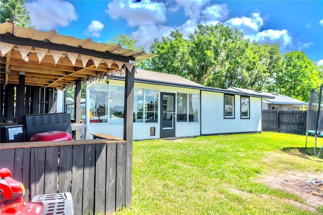 3328 Fox Rdg, Winter Haven, FL 33884 - rear view of property with a trampoline, a sunroom, and a fenced backyard