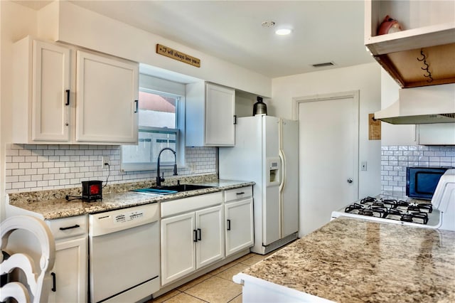 3328 Fox Rdg, Winter Haven, FL 33884 - kitchen with white appliances, extractor fan, decorative backsplash, and white cabinets