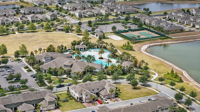 aerial view of residential area featuring a pool area and a large body of water
