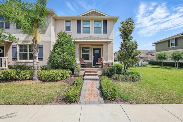 view of property with stucco siding and a front yard