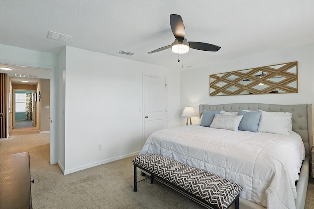 carpeted bedroom featuring baseboards and ceiling fan