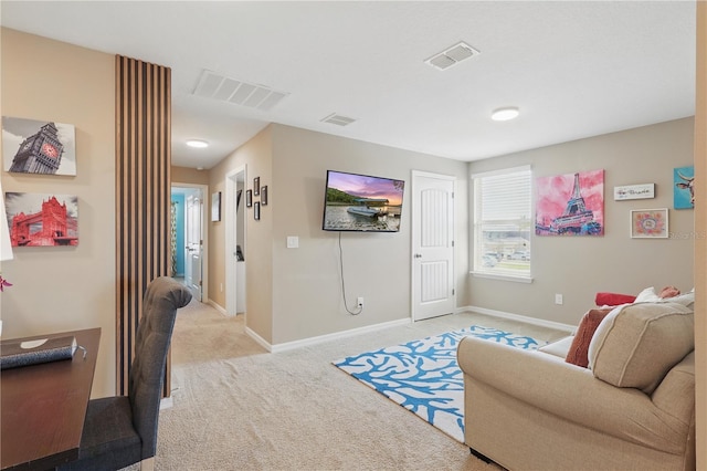 living area with light colored carpet and baseboards