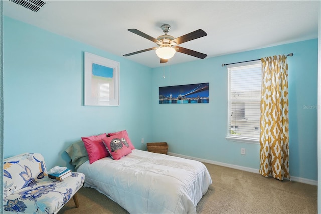 carpeted bedroom with multiple windows, baseboards, and a ceiling fan