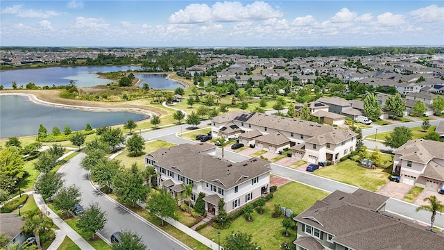 aerial view of residential area featuring a large body of water