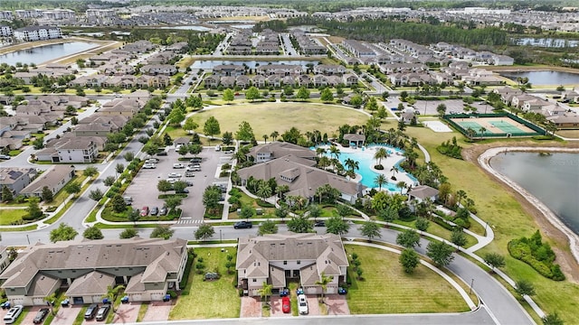 aerial view of residential area featuring a large body of water and a pool area