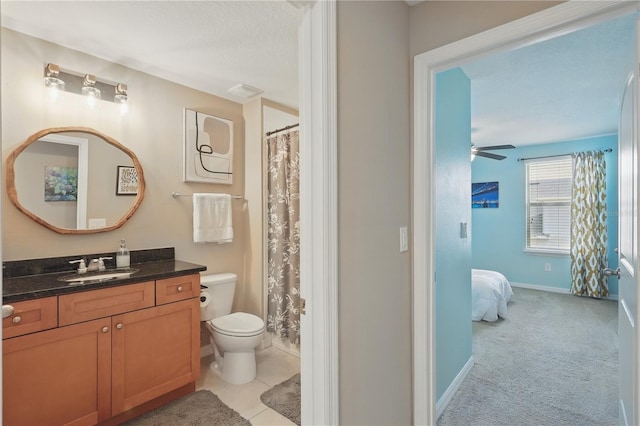 full bathroom featuring ceiling fan, toilet, baseboards, vanity, and ensuite bath