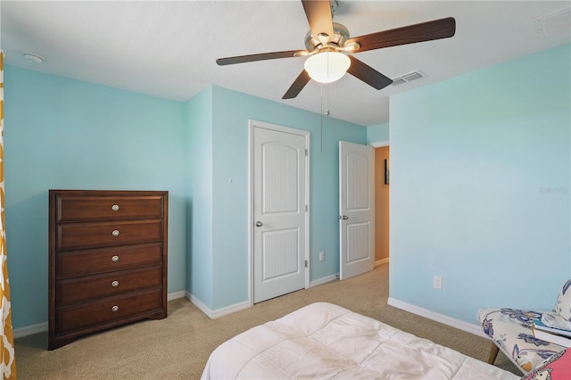 bedroom with light colored carpet, baseboards, and a ceiling fan