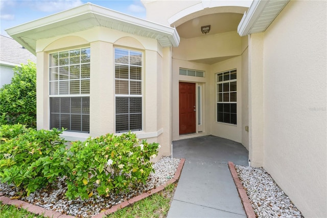 14208 Morning Frost Dr, Orlando, FL 32828 - view of exterior entry featuring stucco siding