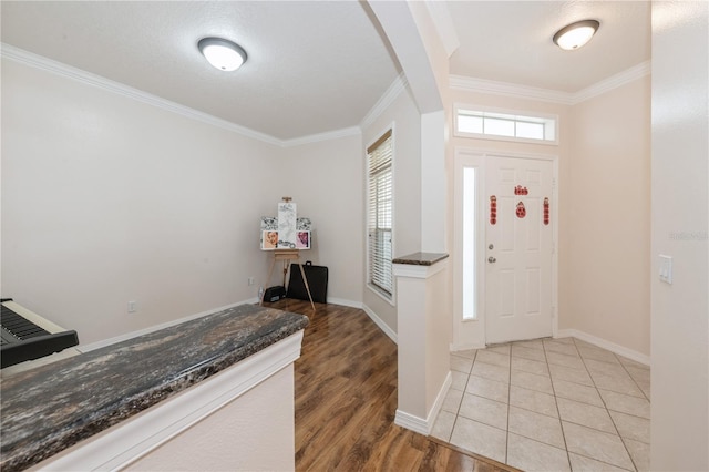 14208 Morning Frost Dr, Orlando, FL 32828 - foyer entrance featuring baseboards, ornamental molding, and light wood-style floors
