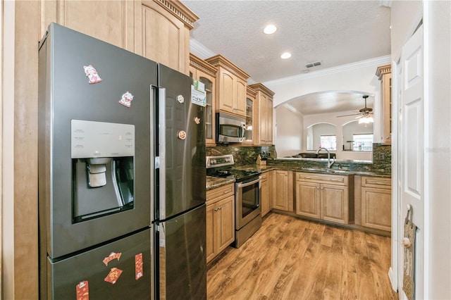 14208 Morning Frost Dr, Orlando, FL 32828 - kitchen with a sink, ornamental molding, stainless steel appliances, and light brown cabinetry