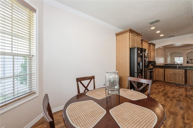 14208 Morning Frost Dr, Orlando, FL 32828 - dining space featuring ornamental molding, baseboards, dark wood-type flooring, and visible vents