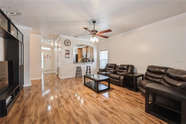 14208 Morning Frost Dr, Orlando, FL 32828 - living room featuring crown molding, a wealth of natural light, a ceiling fan, and light wood finished floors