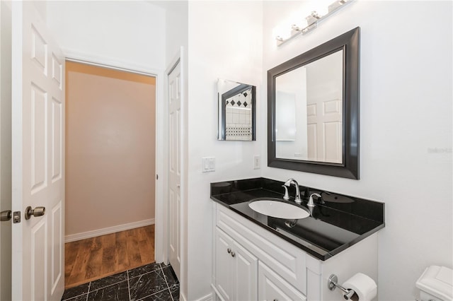 14208 Morning Frost Dr, Orlando, FL 32828 - bathroom with vanity, toilet, baseboards, and marble finish floor