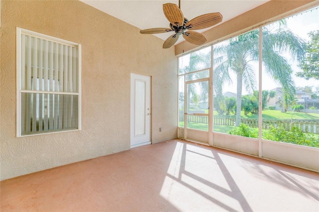 unfurnished sunroom with a textured wall and carpet