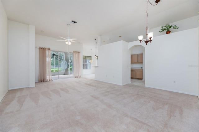 unfurnished living room with baseboards, light carpet, visible vents, and ceiling fan with notable chandelier