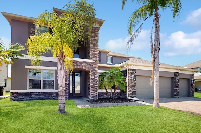 4002 Scarlet Branch Rd, Orlando, FL 32824 - view of front of property with a garage, a front lawn, stone siding, stucco siding, and driveway