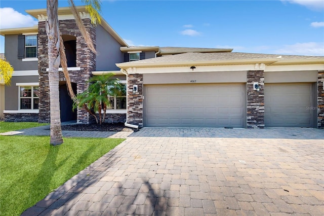 4002 Scarlet Branch Rd, Orlando, FL 32824 - view of front of home featuring a garage, decorative driveway, and stucco siding
