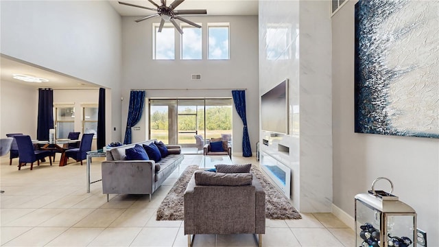 4002 Scarlet Branch Rd, Orlando, FL 32824 - living area with visible vents, a ceiling fan, a high ceiling, and light tile patterned floors