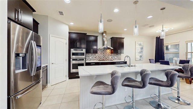 4002 Scarlet Branch Rd, Orlando, FL 32824 - kitchen featuring wall chimney range hood, backsplash, a sink, stainless steel appliances, and recessed lighting